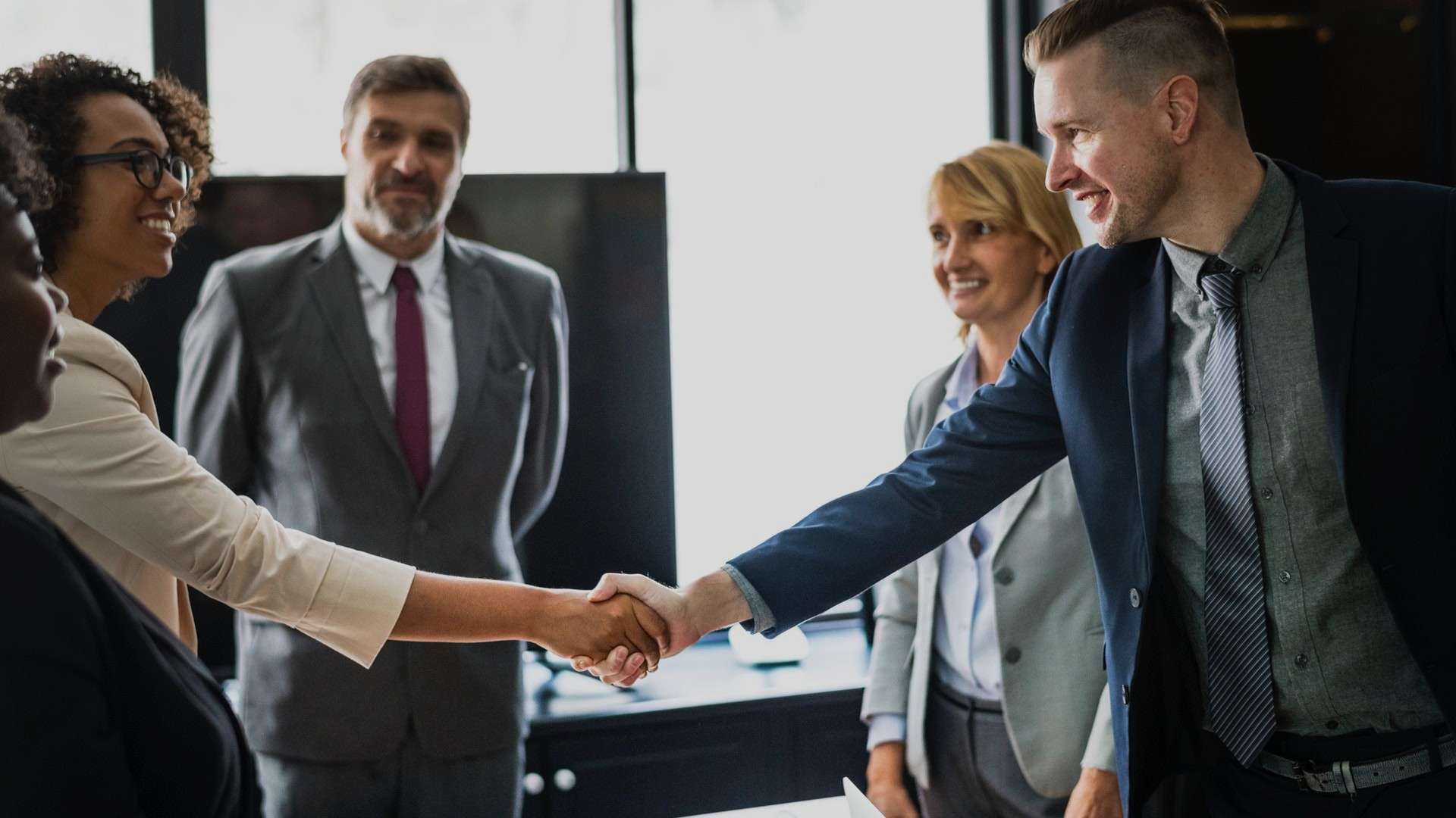 conflict-of-interest-office-people-shaking-hands