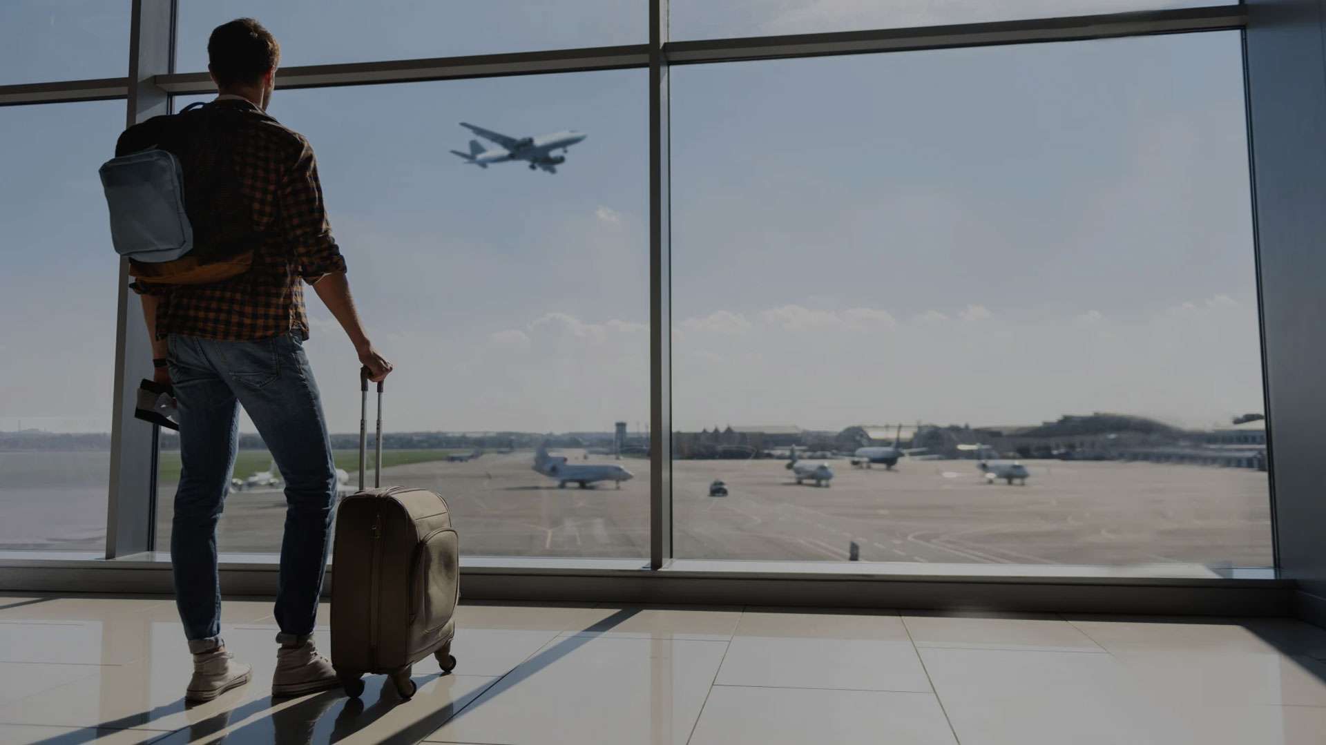 Businessman using a laptop while computing business expenses - checking company's travel and expense policy.