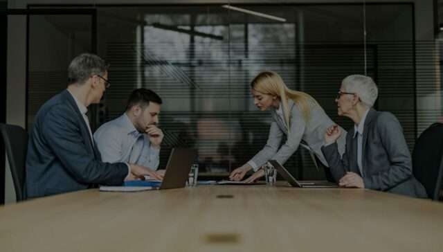 Government officials in an office during a meeting - using register of interests software to avoid legal risks