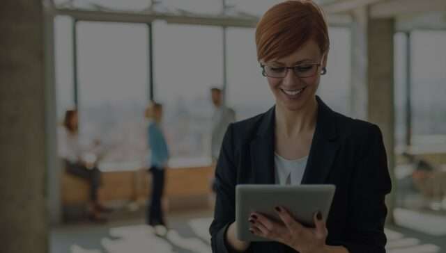 Female manager in an office using gifts register software on a tablet device